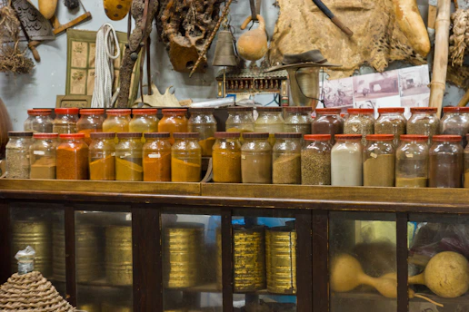clear glass jars on blue wooden shelf