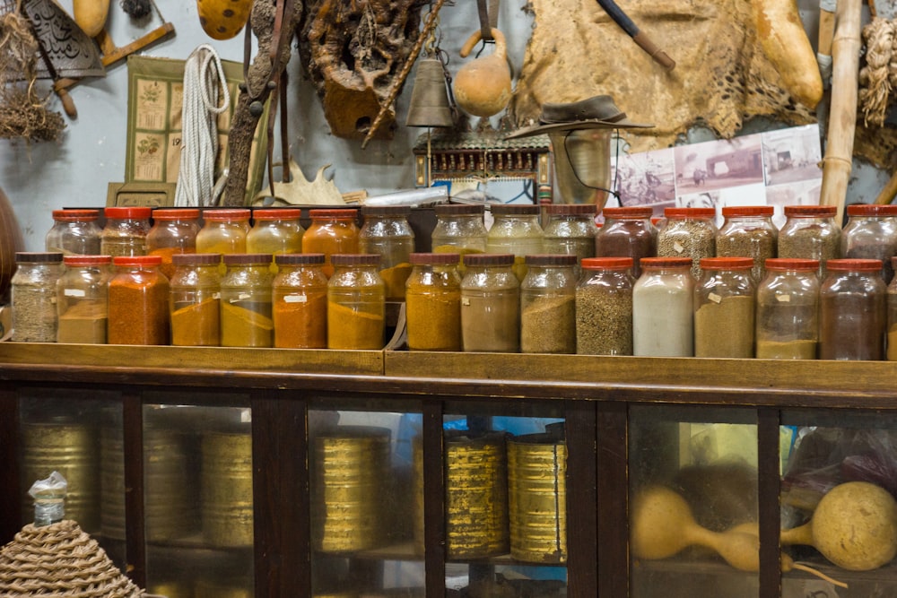 clear glass jars on blue wooden shelf