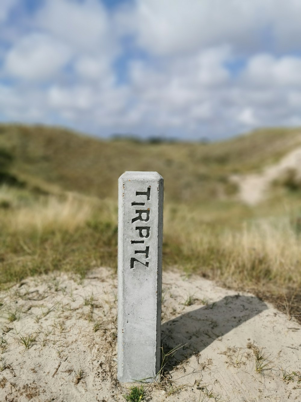 white and black cross signage on brown soil