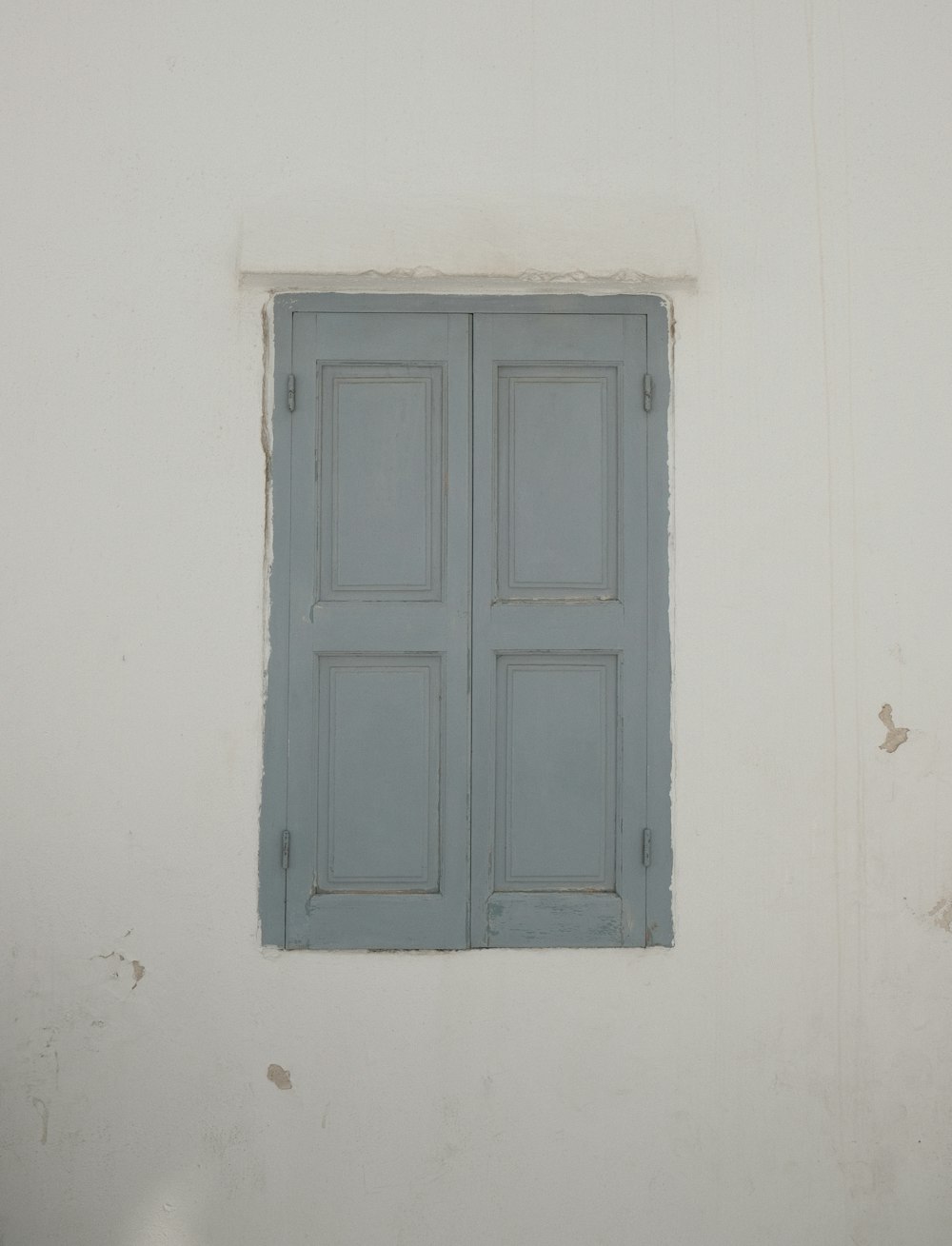 white wooden door on white painted wall