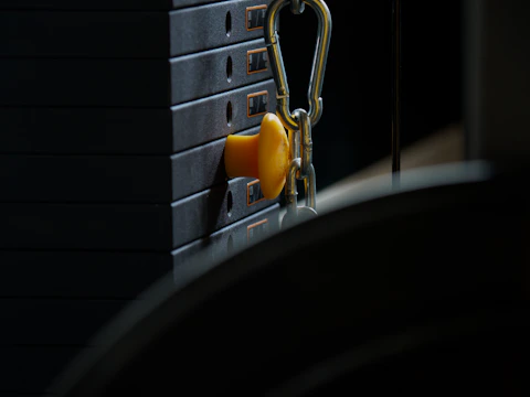 Close-up of a custom strength training machine in a bright gym setting.
