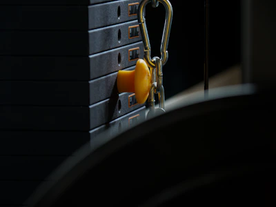Close-up of hands adjusting weights on a training machine in a bright fitness studio