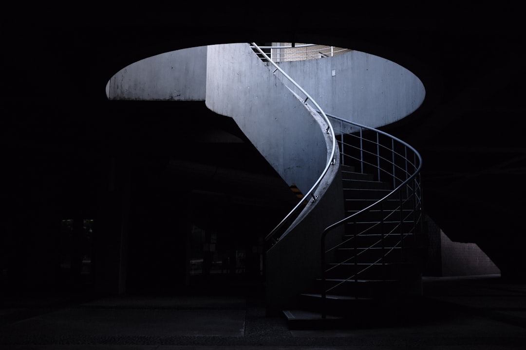 black spiral staircase with stainless steel railings