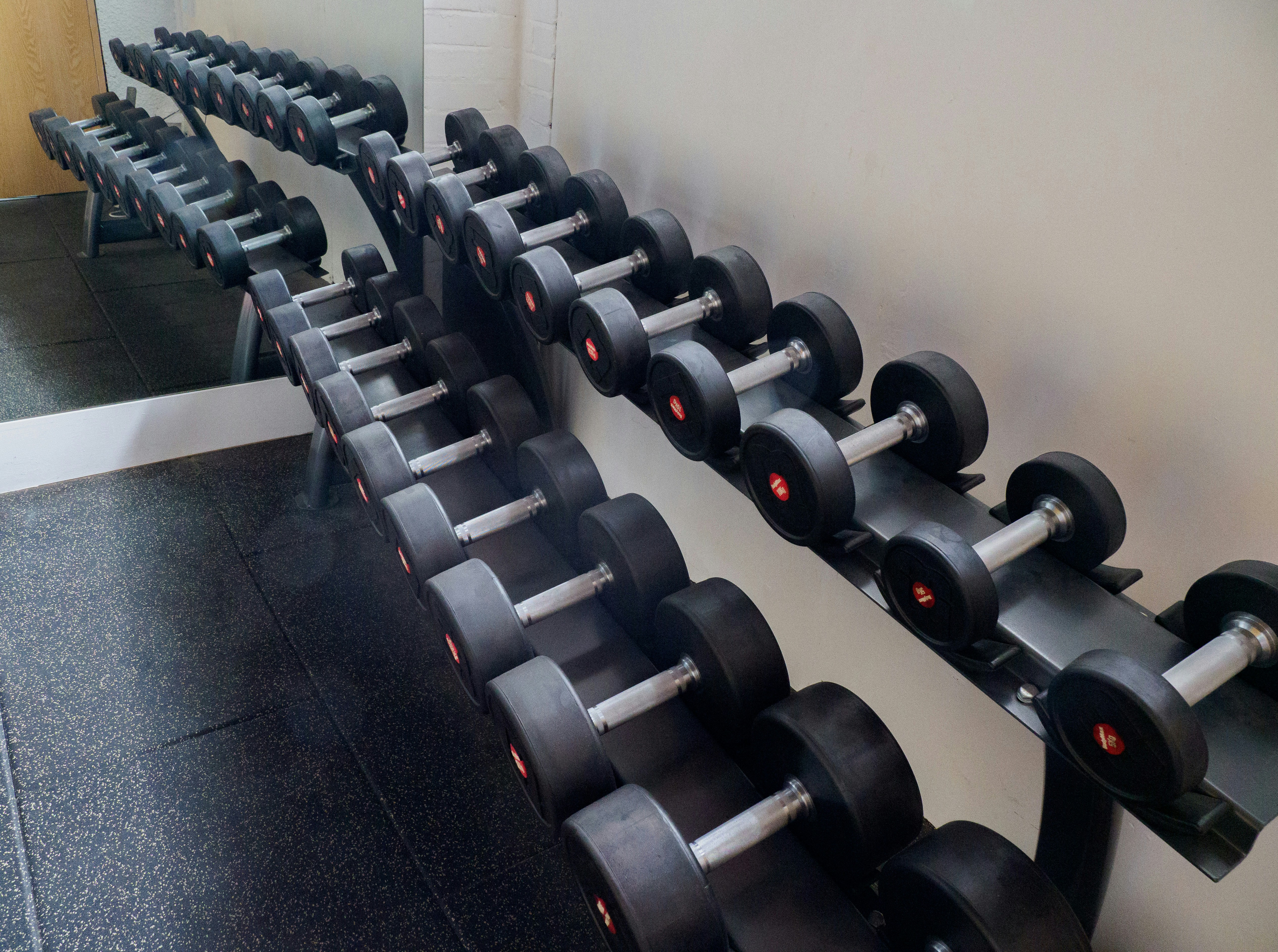 black and gray dumbbells on black bench