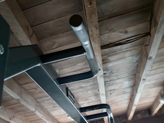 A sturdy pull-up bar mounted on a doorway, ready for use in a home gym setup.