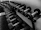 Close-up of premium gym weights arranged neatly against a stylish gray wall.