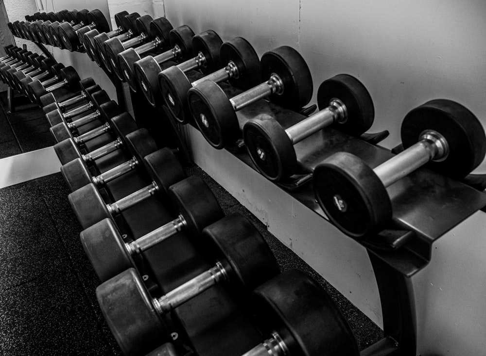 black and silver dumbbells on black steel rack