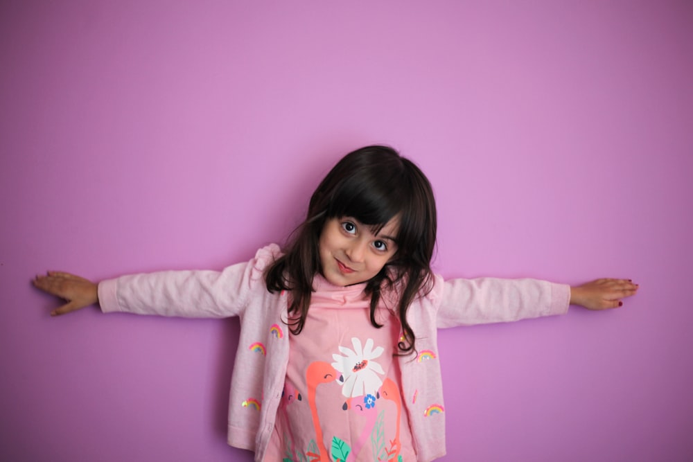 girl in pink and white floral long sleeve shirt