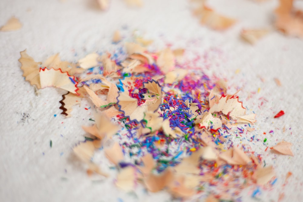 pink yellow and white powder on white textile