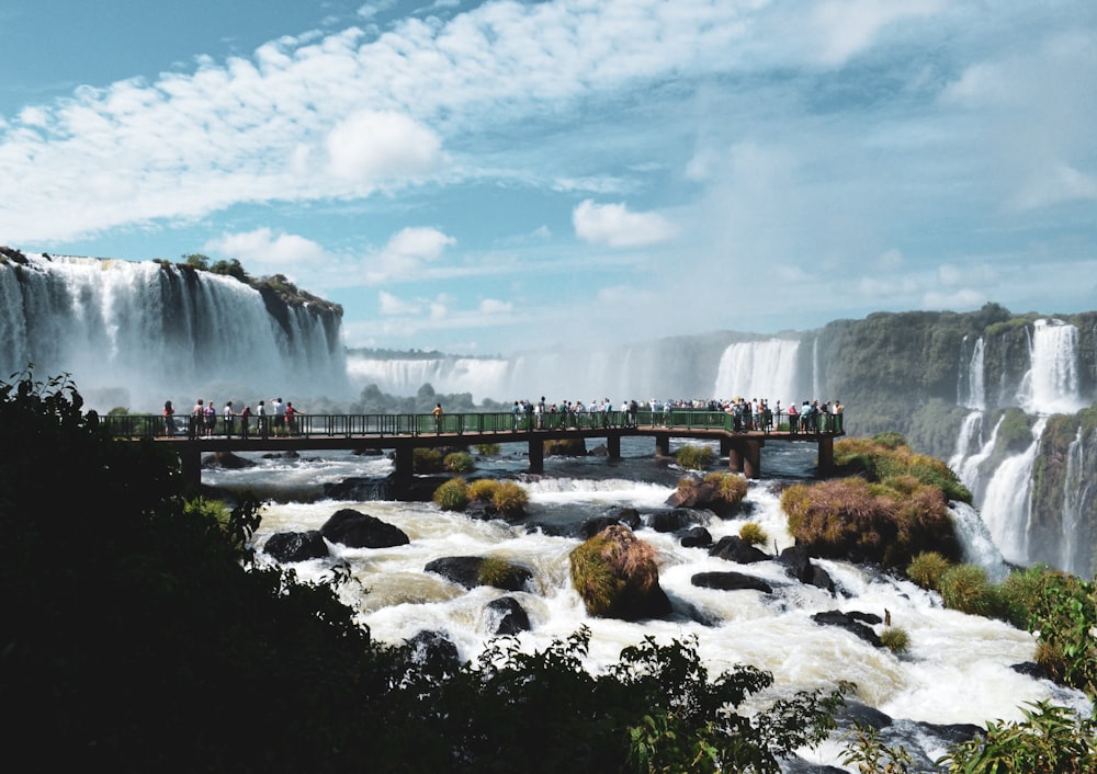 water falls under blue sky during daytime