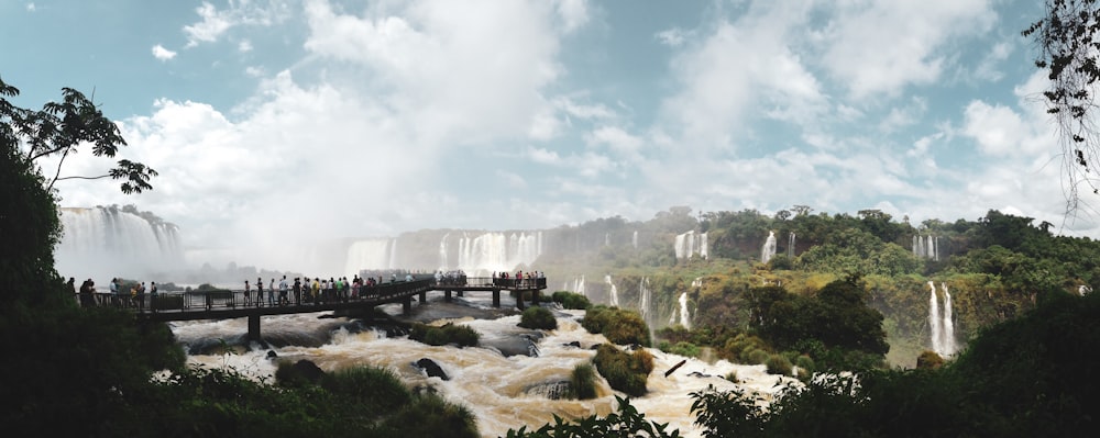 people standing on rock formation near body of water during daytime