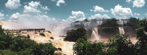A panoramic view of the Iguazu Falls from a viewing platform.