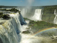 The thundering cascade of Victoria Falls with rainbows arching through the mist.