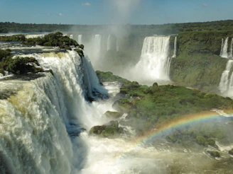 The thundering cascade of Victoria Falls with rainbows arching through the mist.