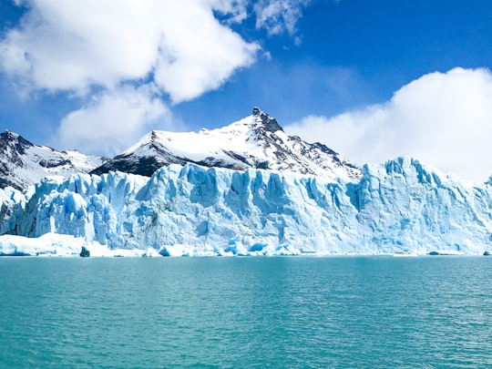 snow covered mountain near body of water during daytime in Glaciar Perito Moreno Argentina