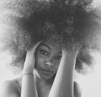 grayscale photo of woman with curly hair