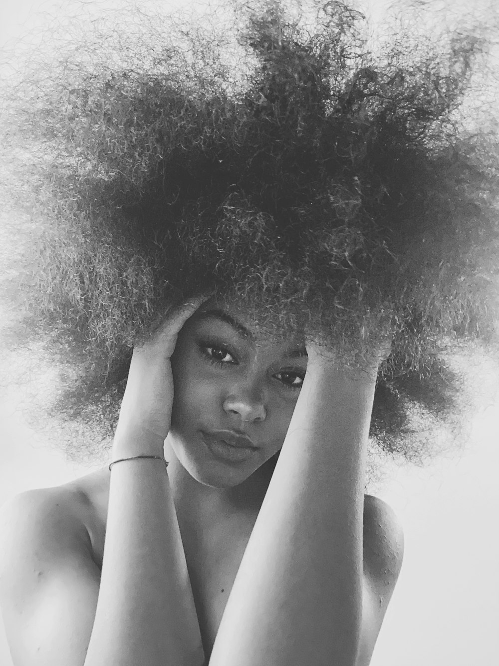 grayscale photo of woman with curly hair