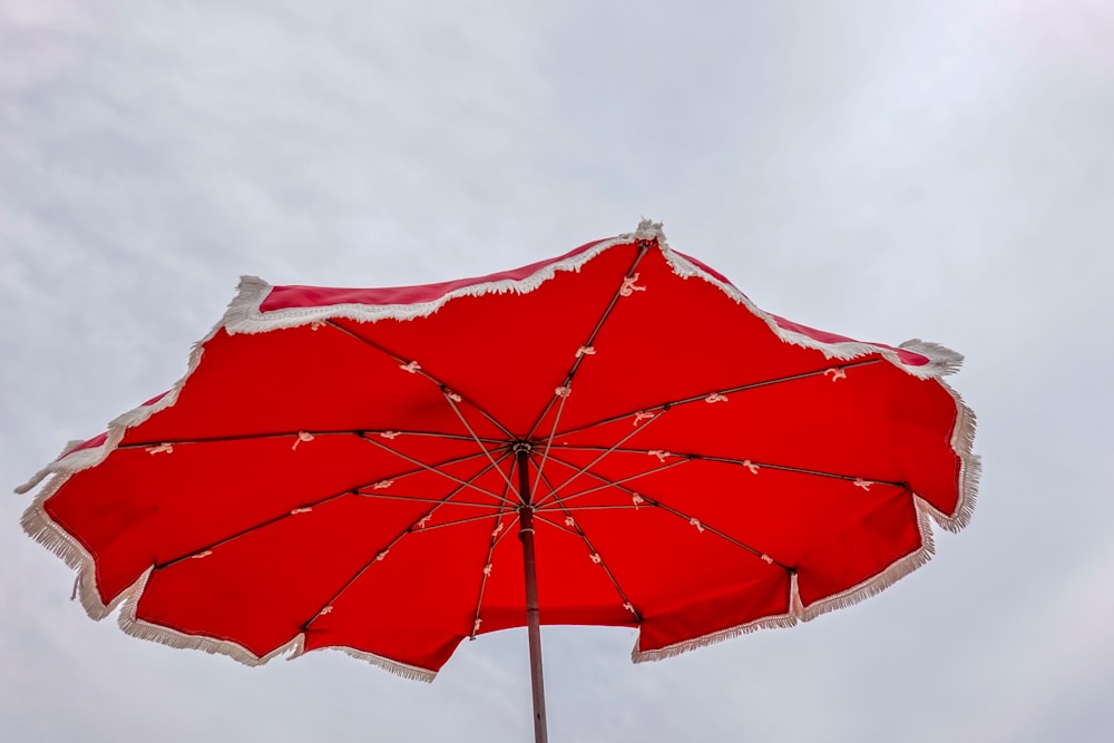 red umbrella under white sky