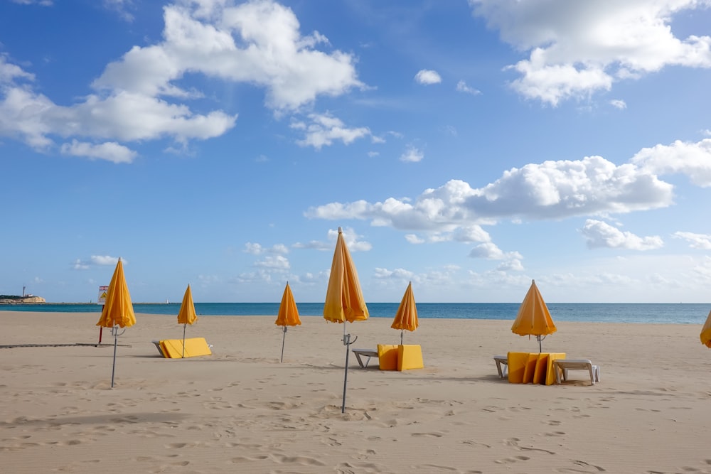 two brown and white beach umbrellas on beach during daytime