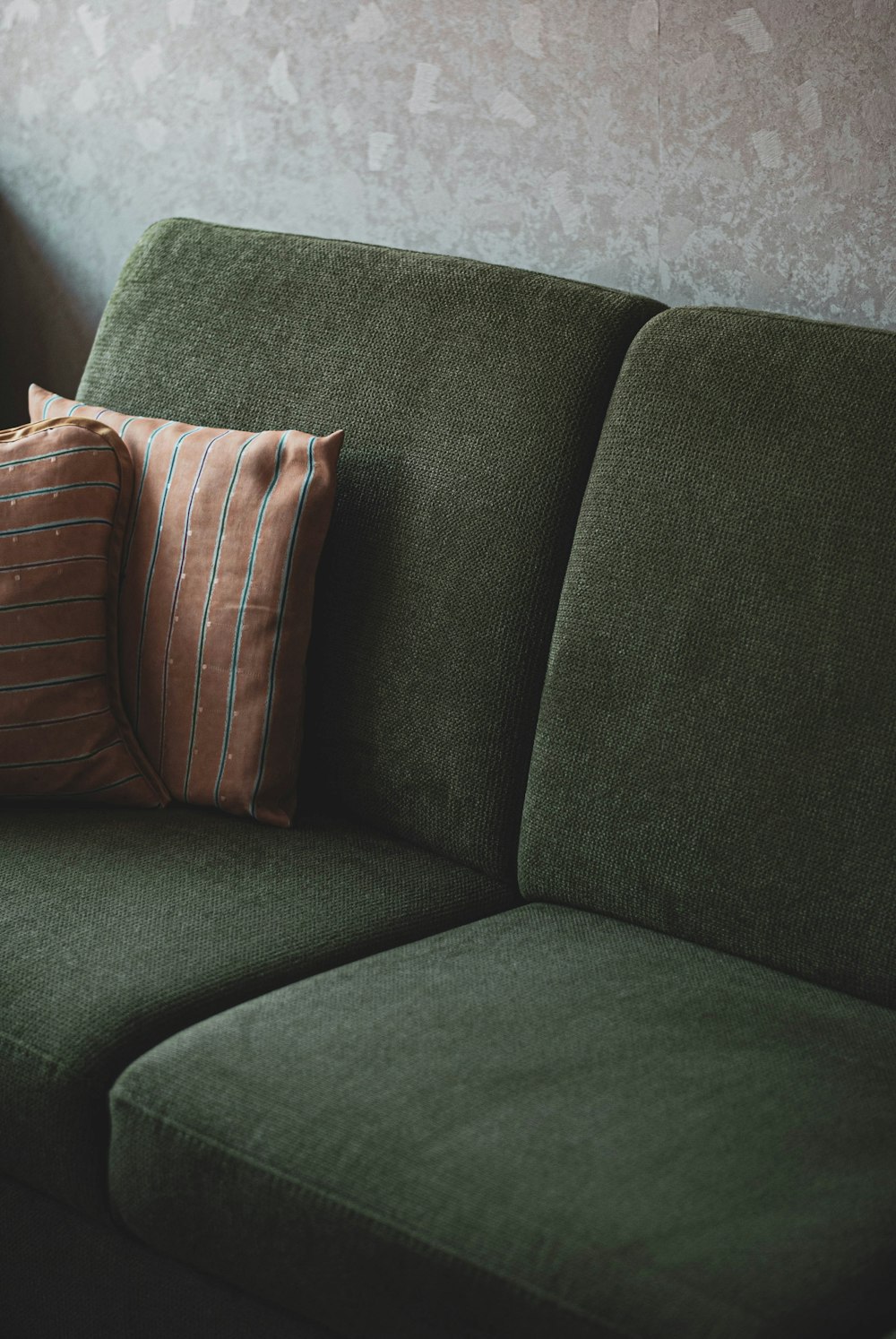 brown throw pillow on gray couch