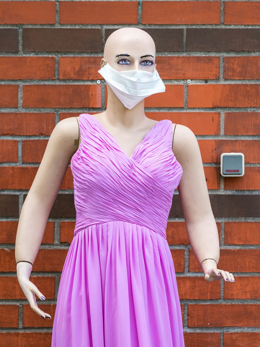 woman in purple tank top wearing white face mask