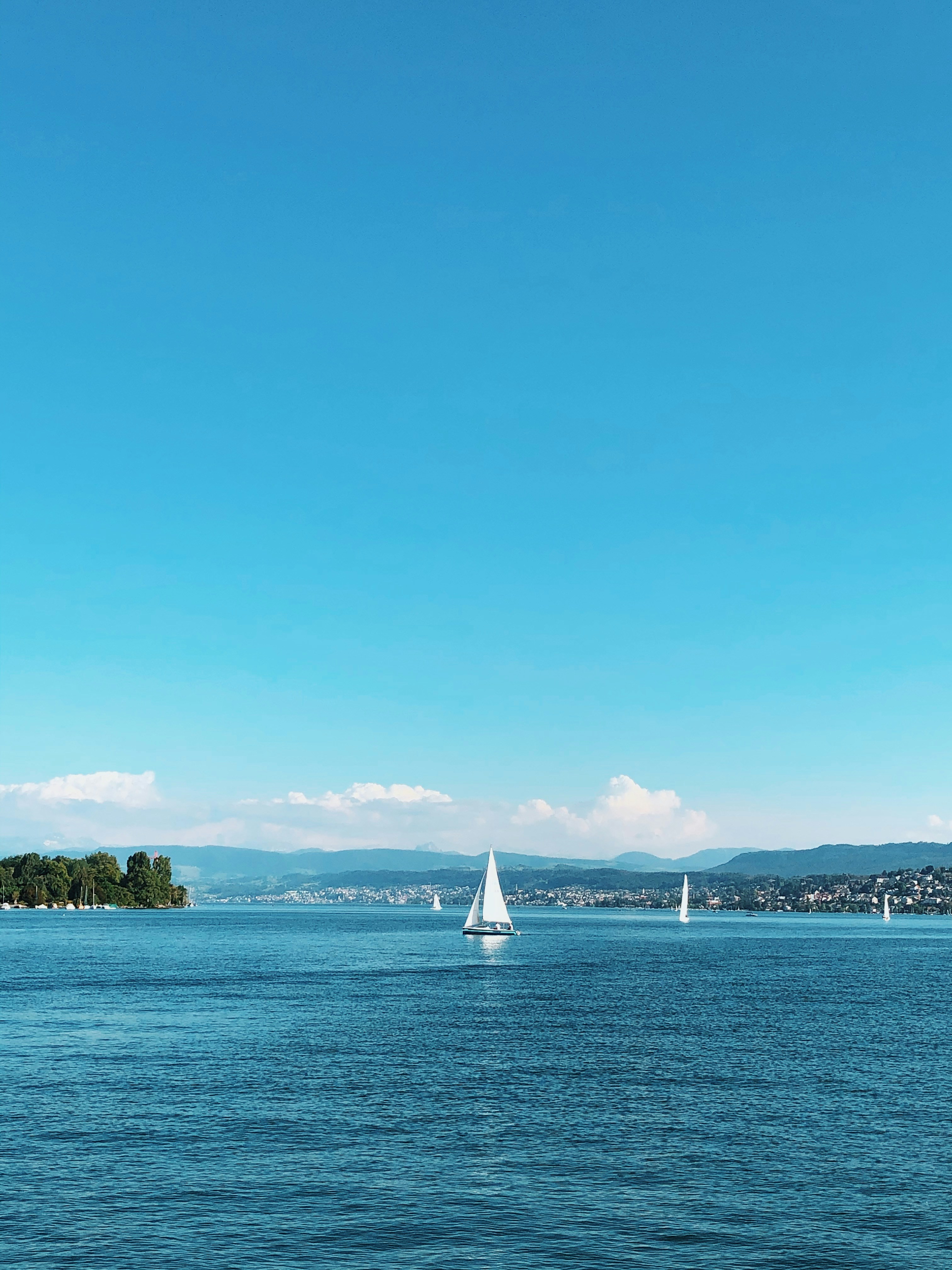 a sailboat in the middle of a lake