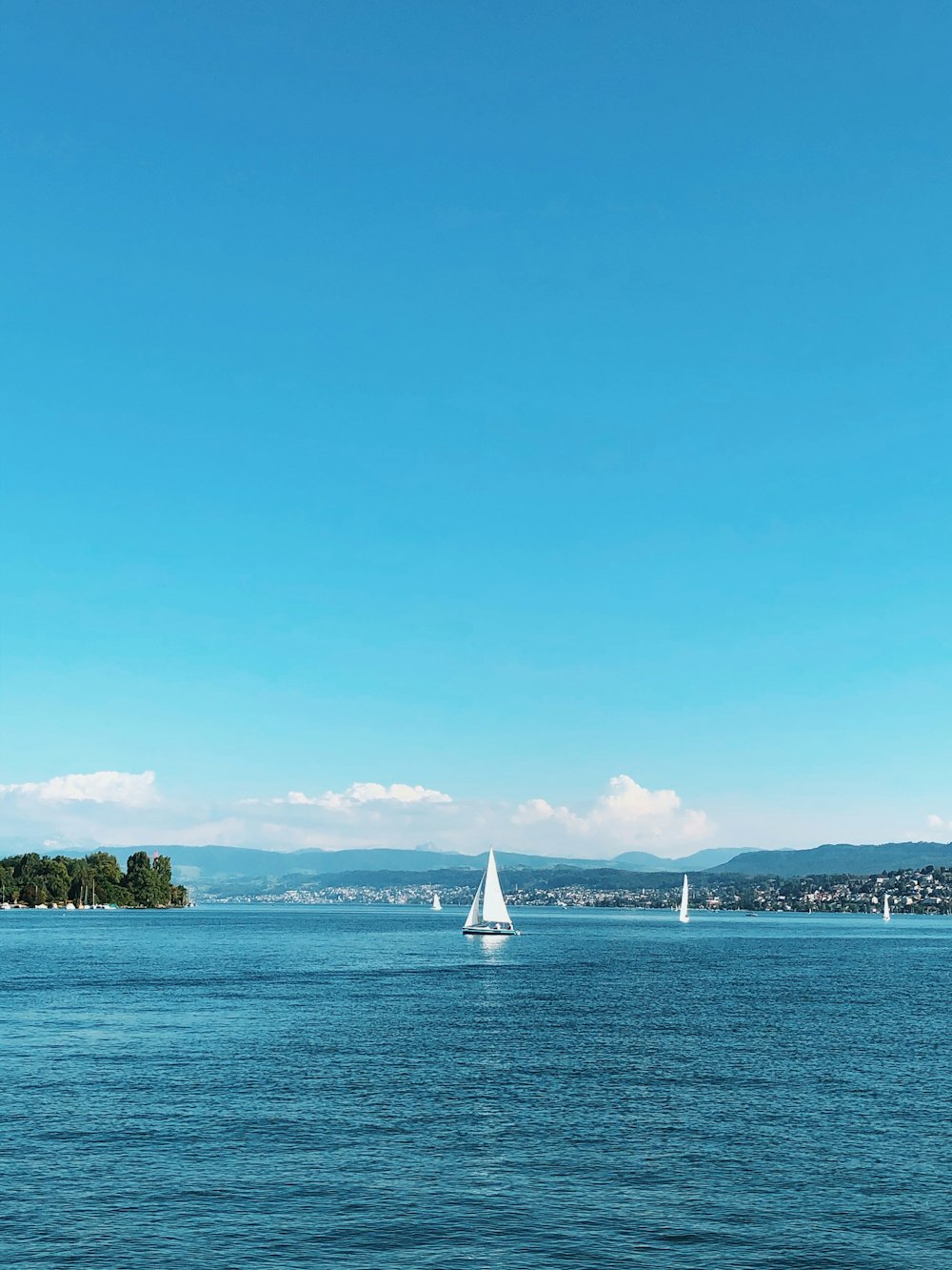 a sailboat in the middle of a lake