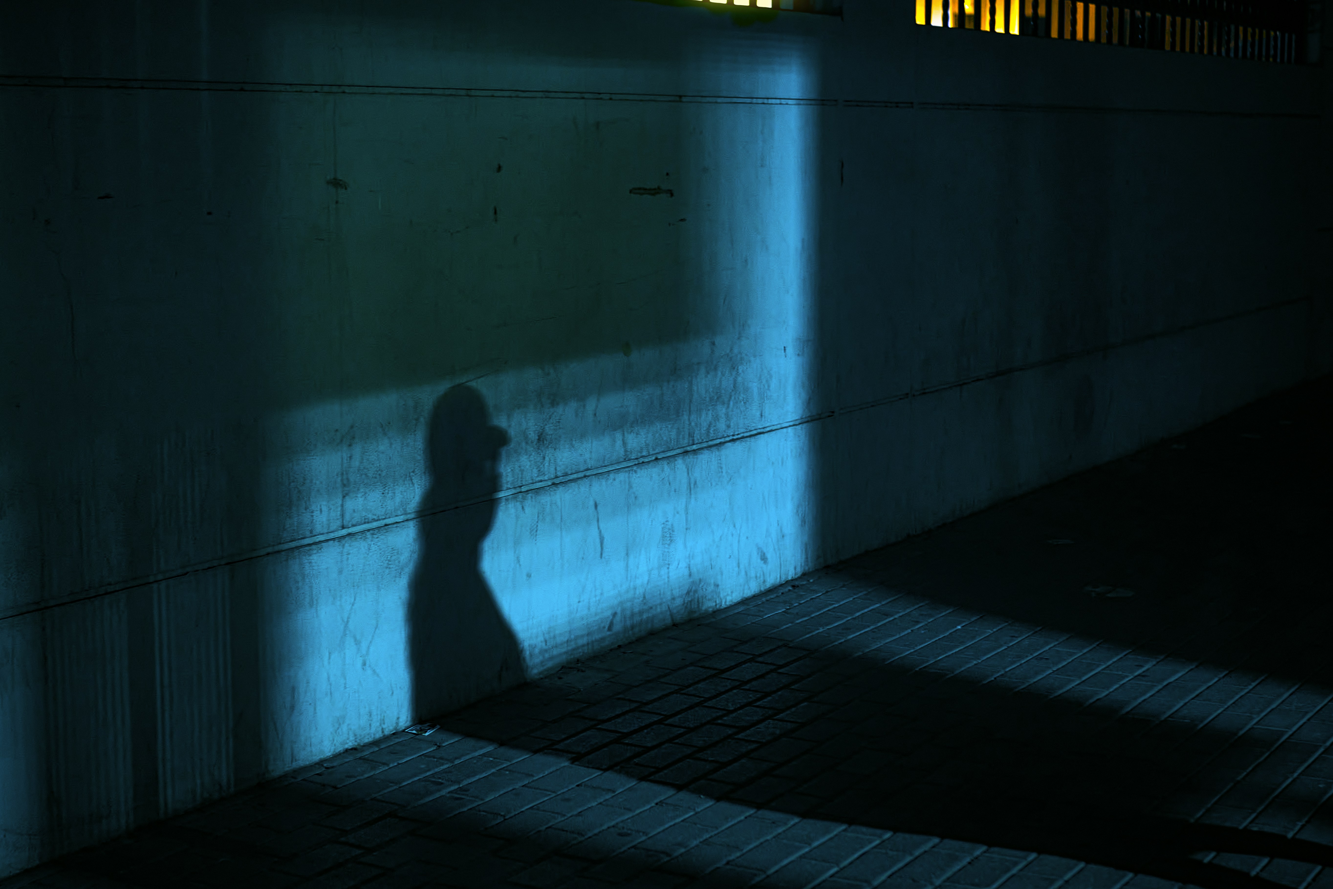 Blue glowing shadow powers emanating from a lone hunter standing in darkness