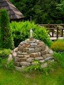 An ancient stone altar surrounded by lush greenery.