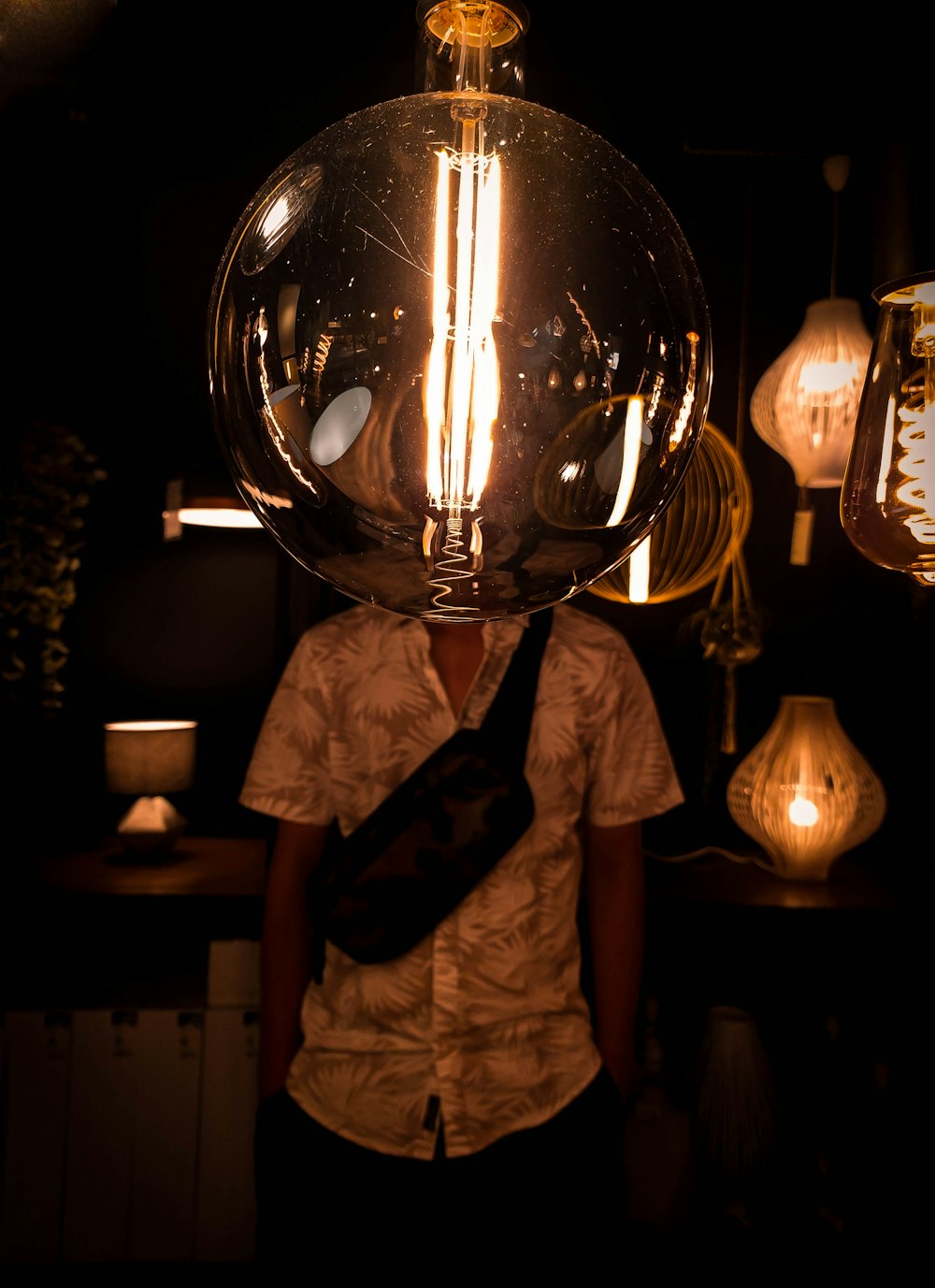 man in white t-shirt holding silver ball