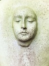white human face carved on white wall