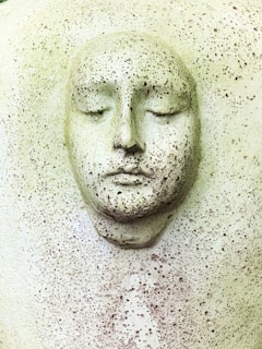 white human face carved on white wall