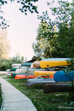 blue and orange kayak on gray concrete road during daytime