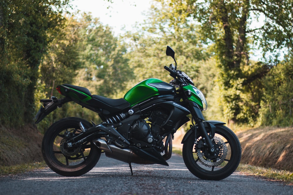 green and black naked motorcycle parked on gray concrete road during daytime