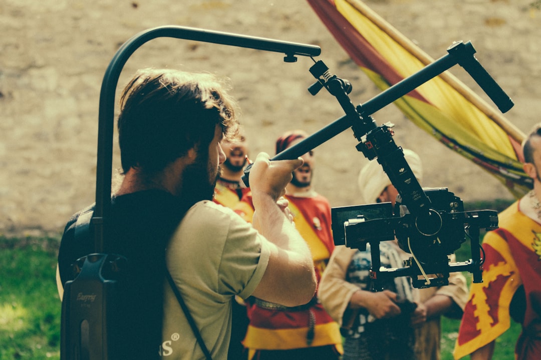 man in black shirt holding black video camera