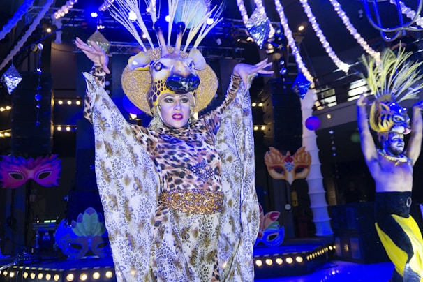 Regal Rhythm performing on stage, wearing an avant-garde Alexander McQueen-style outfit with a hint of Greek god elegance.