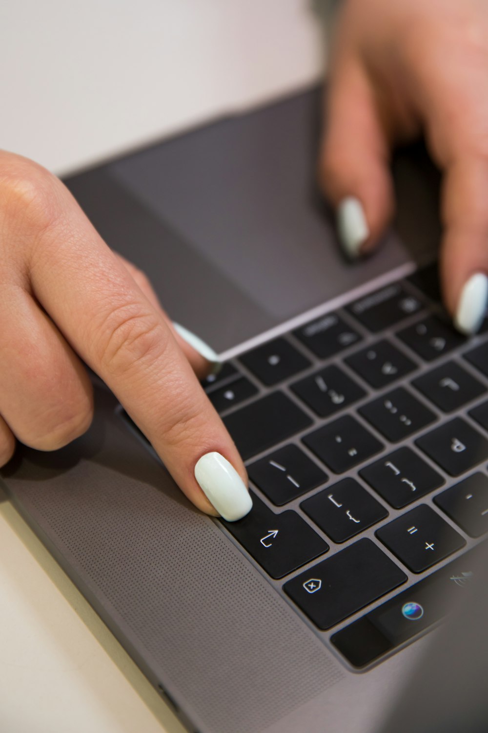 persons finger on macbook pro