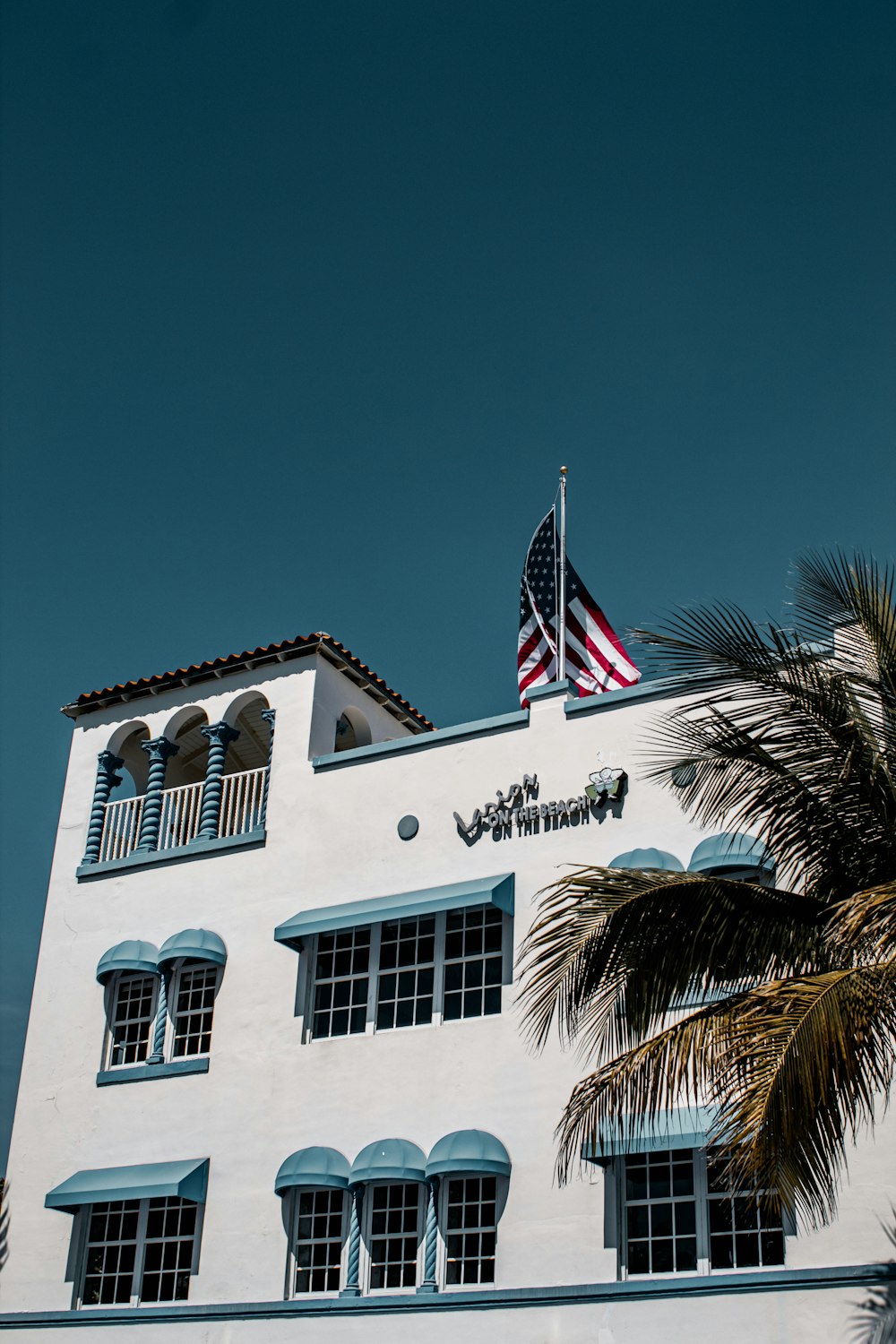 white and brown concrete building with us flag on top