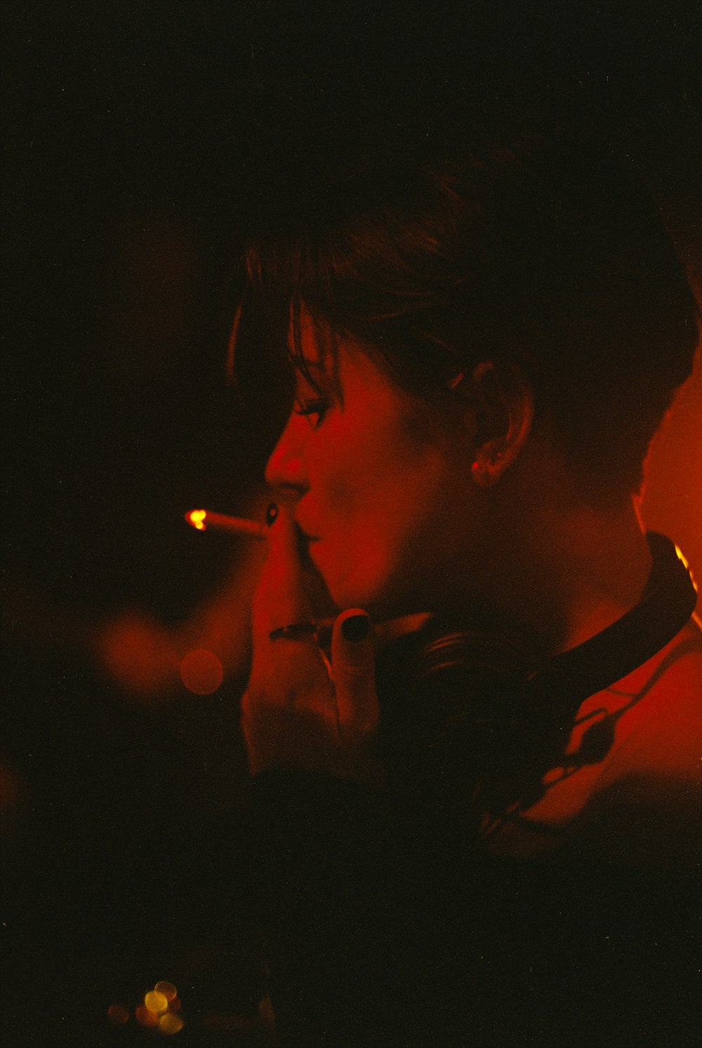 woman smoking cigarette during night time