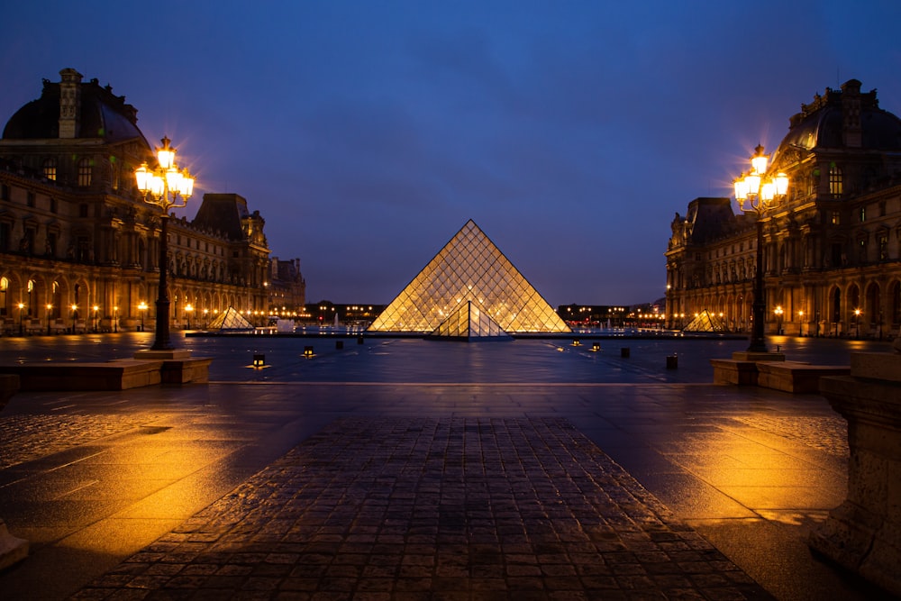 lighted building near body of water during night time