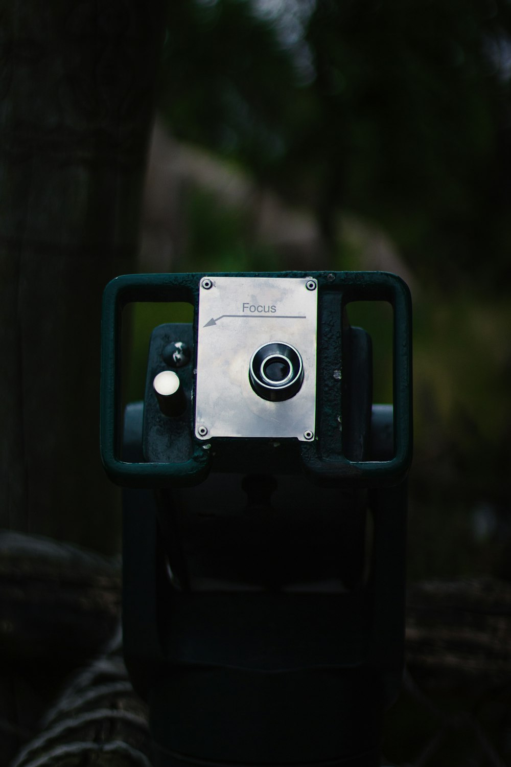 green and black camera on brown wooden surface