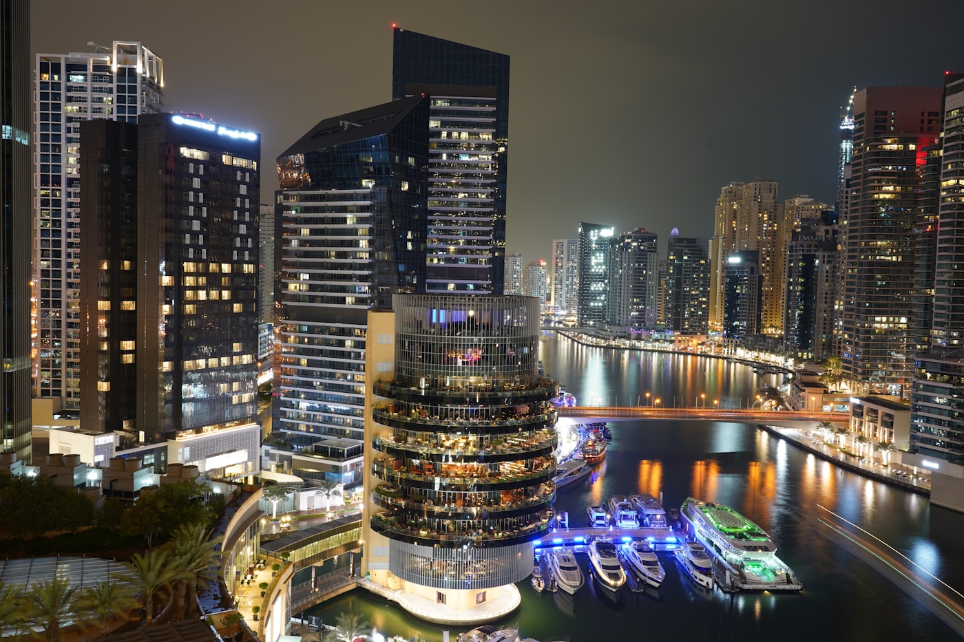 Cluster of modern high-rise towers reflected in an artificial lake at dusk