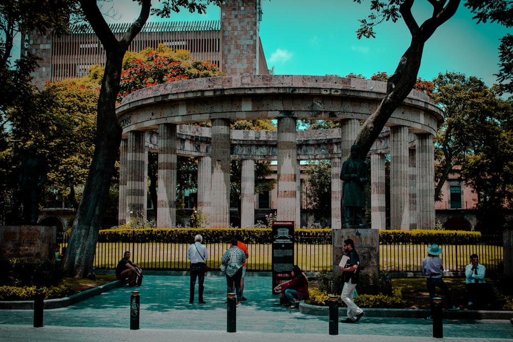 people sitting on bench near building during daytime