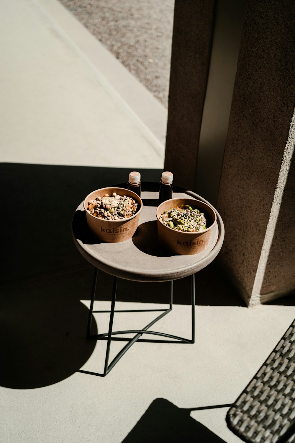 white ceramic bowl on black metal chair