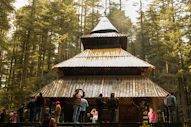people standing near brown wooden house during daytime