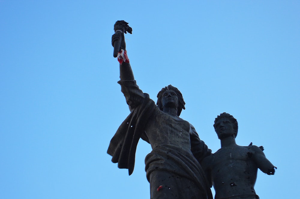 statue of man holding flag