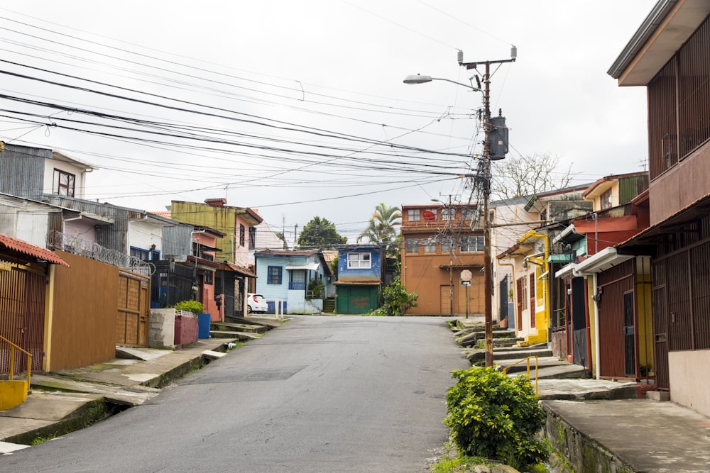 green and brown houses beside road during daytime