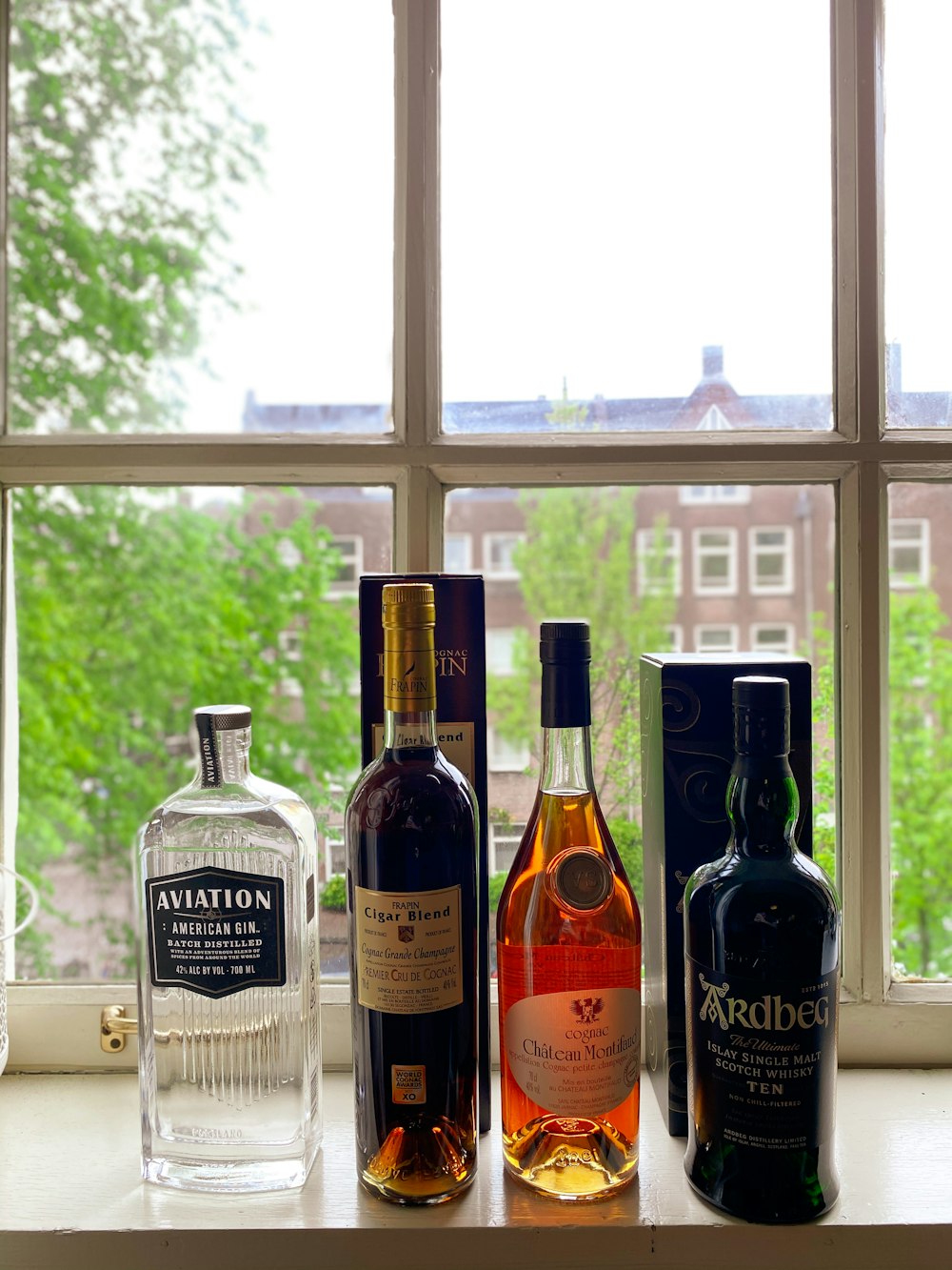 black glass bottles on white wooden shelf