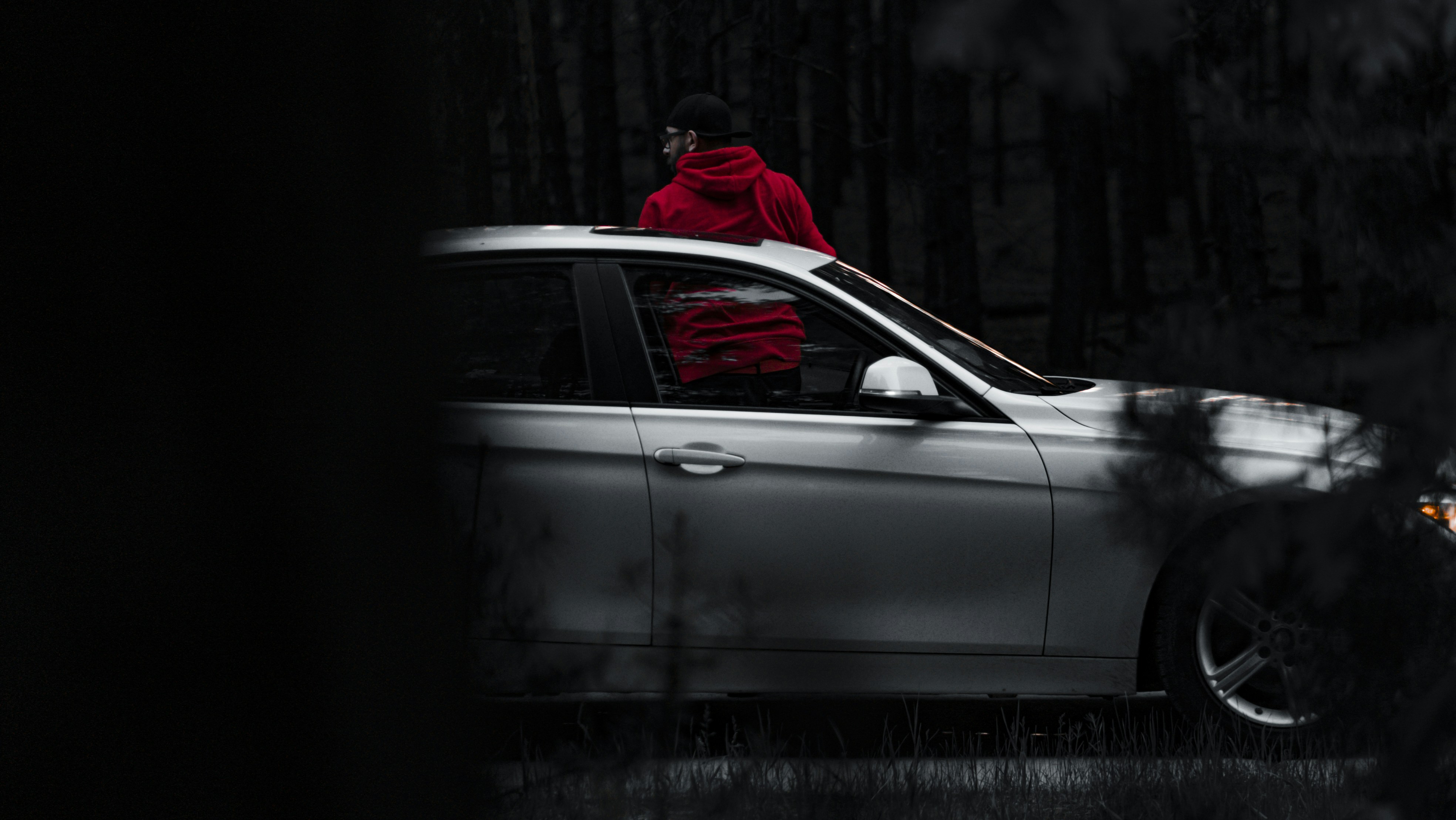 Automotive culture portrait, person in dark environment, moody editorial photography