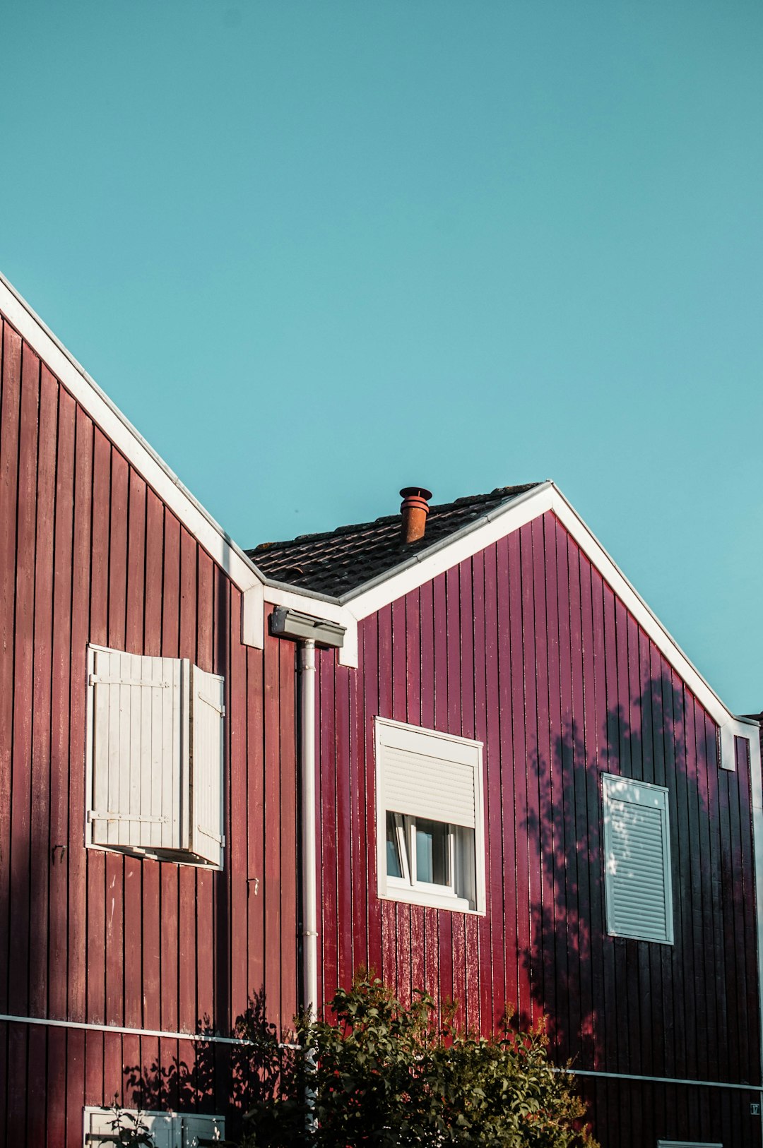 red and white wooden barn under blue sky during daytime